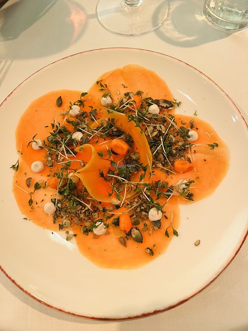 Very thinly sliced beets with micro-green and sea buckthorn salad on top at Vaxthuset in Stockholm