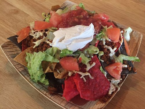 Nachos! Chips with seasoned meatless crumbles, daiya cheeze, tomato, romaine, salsa, and Tofutti sour cream. at Cafe Verve in State College
