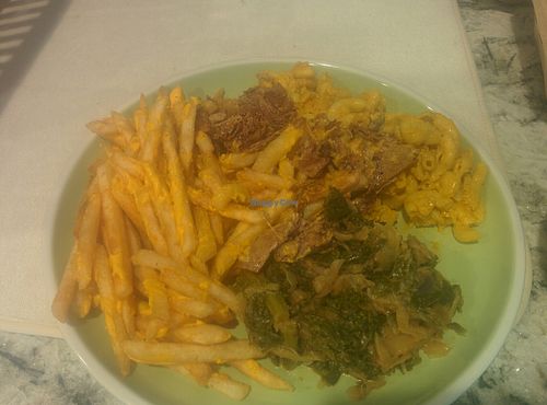 Plated dinner: Philly cheese steak, greens, mac & cheese, cheese fries at The Veg Hub in Oakland
