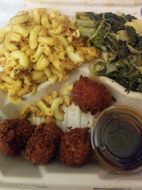 Delicious dinner platter. 3 cheeze Mac & cheeze, soul food greens, fried chicken. teriyaki dipping sauce at The Veg Hub in Oakland