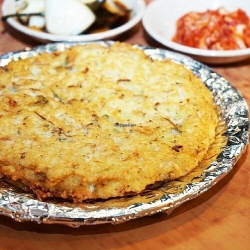 Bindaeddeok with pickled onions and kimchi.  at Soonheene Bindaeddeok - 순희네 빈대떡 in Seoul