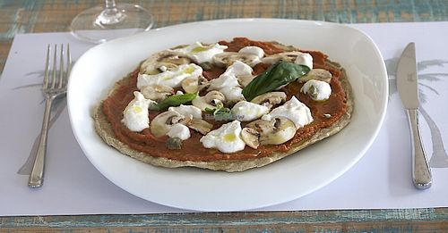 New raw food pizza with mushrooms at HappyRaw Natural Restaurant in Faenza