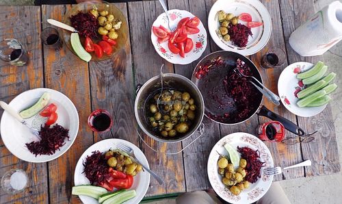 Summer time, ejoying food on table outside. at CostelHostel in Rosu