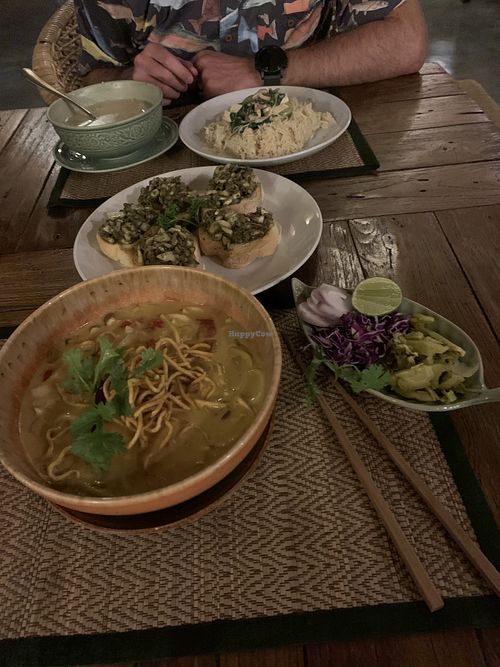 Northern Thai Spicy Noodle Soup, green curry, pesto mushroom bruschetta  at Reform Kafe in Chiang Mai