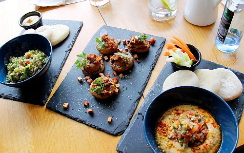 Three dishes: tabouleh, stuffed mushrooms and hummus.  at Organic Cafe in Fuengirola