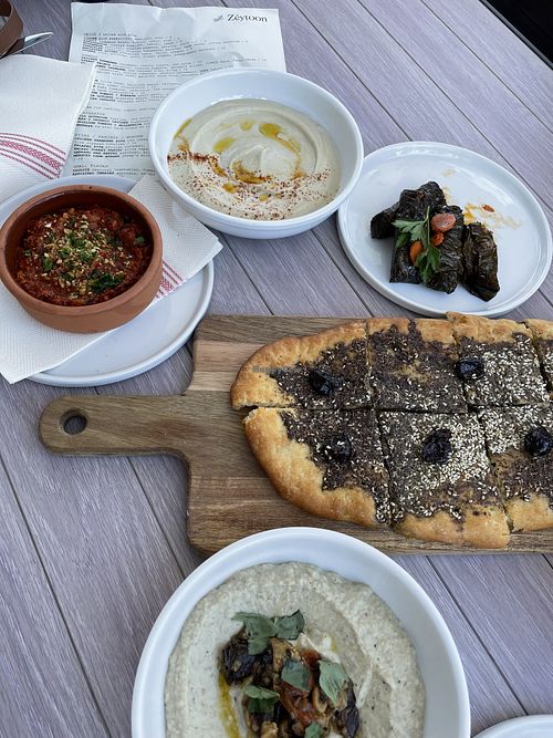 From left to right: Muhammara, hummus, dolmas, maneesh, and babaganoush  at Zeytoon Cafe in Laguna Beach