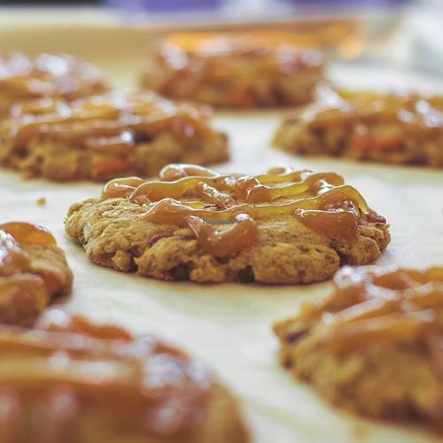 The Dolled Up Cookie: a chocolate chip, pecan, pretzel and caramel sauce covered crunchy cookie. at Dolled Up Desserts in Hamilton
