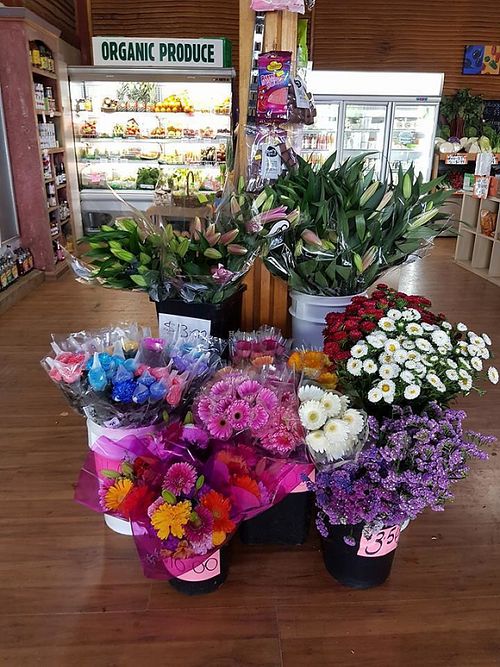 Flowers, Organic Produce and it's too small to see but there's vegan cheeses and butter in the fridge up the back! :) at The Spud Shed in Trafalgar