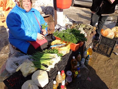 Fresh herbs, dill, parsley and other vegetables, pickled chillies this woman is selling everyday at street market in Cahul. at Street Market in Cahul