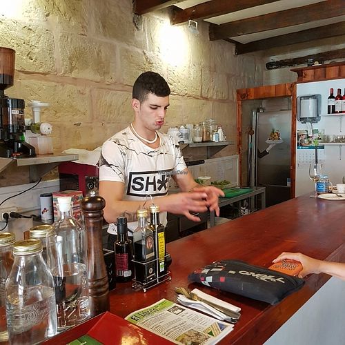Young Juan Carlos is  a delight and makes time for his customers.We really applaud his take on delicious fair food.If you are lucky he will give you one of his recipes.Here on the picture he is giving one ( oven baked watermelon & watermelon vinagret! Whoa! at Vegetando in Fuerteventura