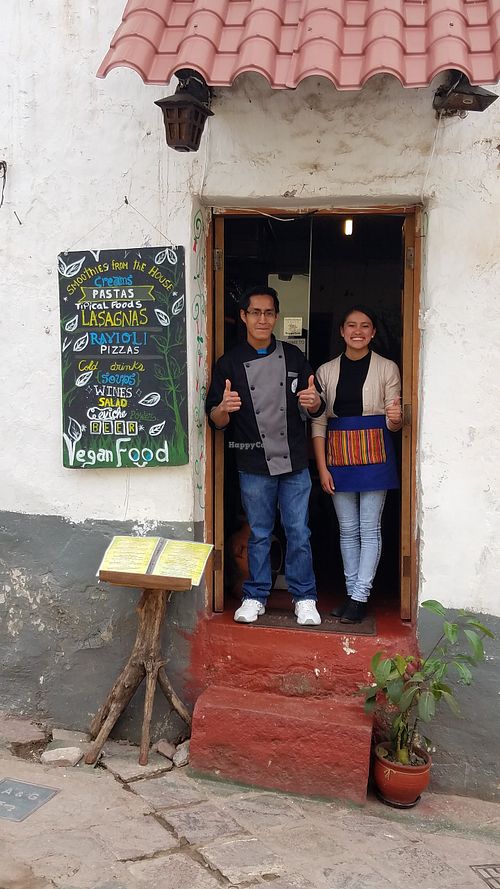 Owners at entrance at Vida Vegan Bistro in Cusco