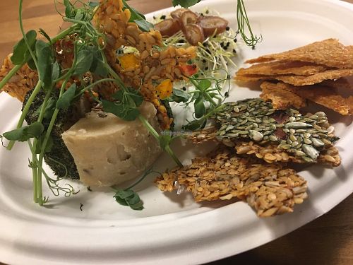 Variety of raw cheese and crackers at Say Cheez Raw in Budapest