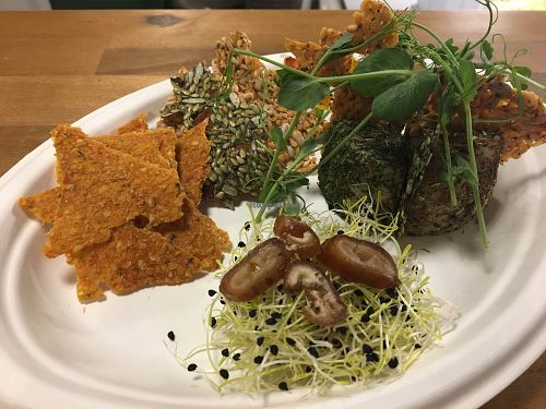 Variety of raw cheese and crackers at Say Cheez Raw in Budapest