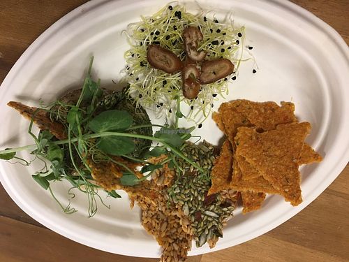 Variety of raw cheese and crackers at Say Cheez Raw in Budapest