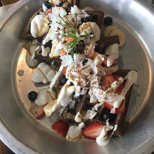 Vegan gluten free waffles with vanilla cashew cream and fresh berries at Harvest Cafe in Ventura