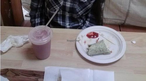 Avocado wrap, strawberry banana soymilk shake, and fries (toward the front.) Also you can see the cloth in the back that seperates the cafe from La Sierra Natural Foods store. at Oasis Vegetarian Cafe in Riverside