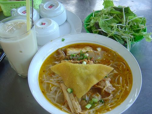 My rice noodle bowl with a glass of soy milk at Com Chay in Chon Thanh