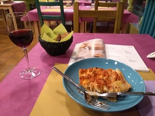 Lasagna, red wine (also vegan) and lots of vegan recipe books to look through. at Cardamomo Cucina Vegana in Arona