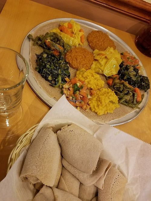Veggie combination platter #1 (for two) pictured with a partial basket of the many rolls of injera that came with it. DELICIOUSSSSS! at Ahadu in Burtonsville