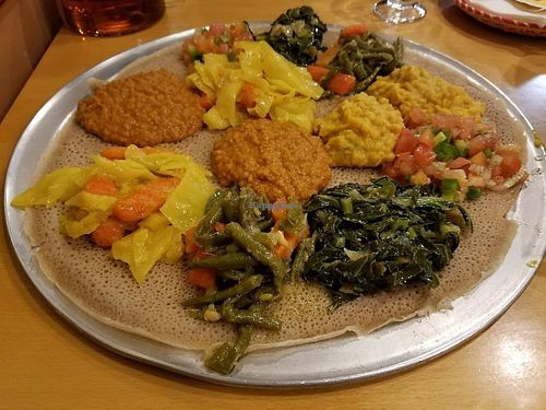 Veggie Combination #1 platter (for two). Comes with cabbage & carrot, red lentils, split peas, green beans &carrot, collard greens, and tomato salad. at Ahadu in Burtonsville