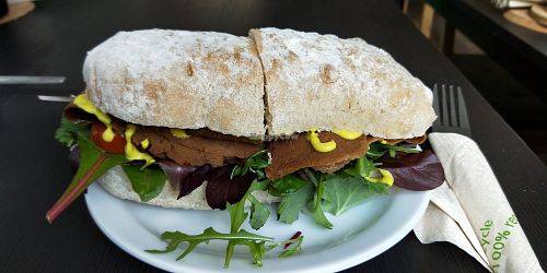 Homemade seitan on a ciabatta roll with fresh salad at Grassroots Health in Edinburgh