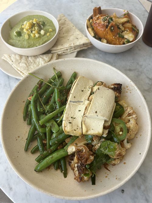 Avocado hummus, tofu, kungpow califlower, sichuan beans and snap peas, and roasted sweet potatoes   at Flower Child in Del Mar