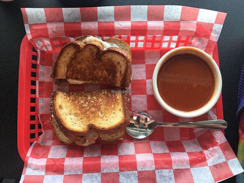 vegan double decker grilled cheese on wheat bread with classic tomato soup.  at Tom + Chee in Katy