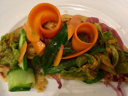 Chickpea flour pizza with zucchini, squash blossom, and onion at Orto & un Quarto in Siena