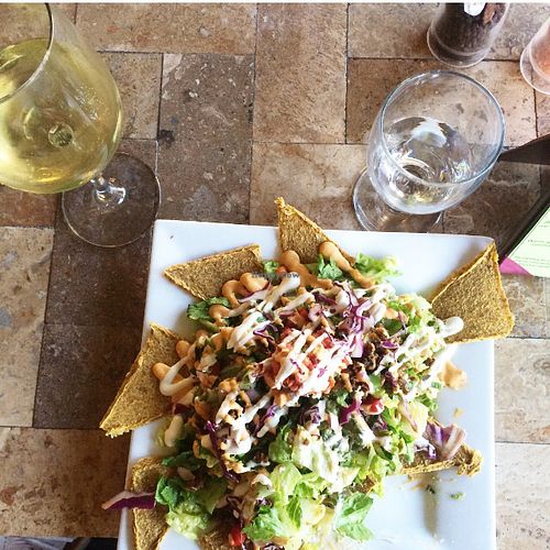 Vegan Nachos with a glass of Pinot Grigio at The Present Moment Cafe and Market in St Augustine