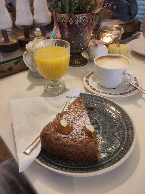 Fresh-pressed orange juice, flat white, vegan cake at Cafe im Süden in Bad Toelz