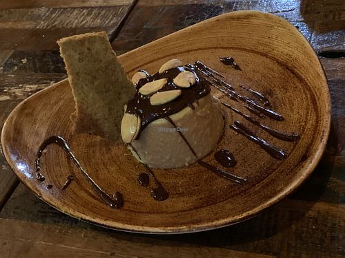 Flan de turrón servido con almendras saladas   at Lluvia in Alicante