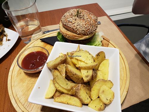 Vegan burger with crispy potatoes and spicy ketchup at Healthy Bites in Athens