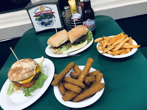 Impossible and portobello burger with a side of zucchini fritters and red fries   at Happy Burger Diner in Mariposa