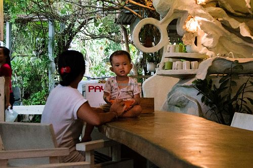 Mom and kid at a table inside of 9 Angels Warung at 9 Angels Warung in Ubud