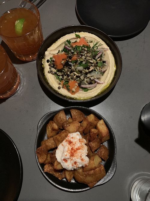 Fekkeh hummus and crispy potatoes with a garlic sauce at The Hummus Club in Northbridge