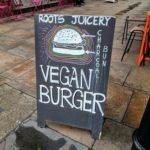 Sign for Roots Juicery vegan burger at Roots Juicery in London