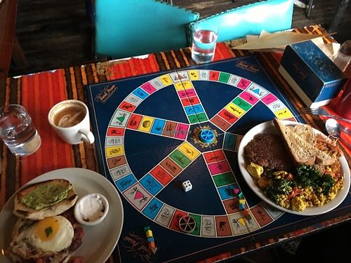 Trivial pursuit. Huevos breakfast slam and cortado on left, vegan tofu scramble breakfast plate on right. at Sweetness 7 Cafe in Buffalo