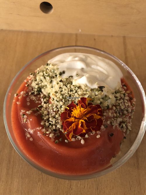 Granola with vegan yogurt and puréed berries sprinkled with some kind of seed  at Sereda in Kyiv