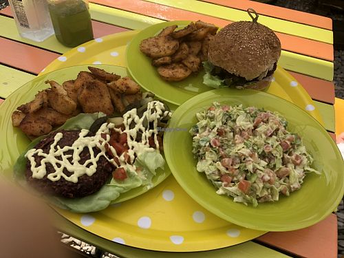 Happy cow burger with oven potatoes and guacamole salad. at Sara Green - Vegan Bistro in Bucharest