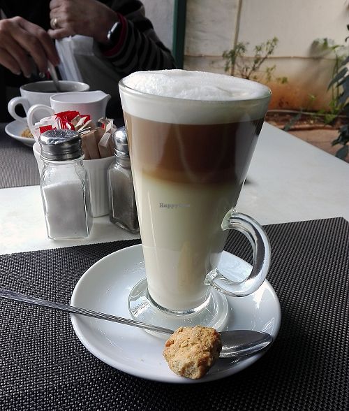 Soy milk latte with vegan biscuit. at The Secret Garden in Benoni