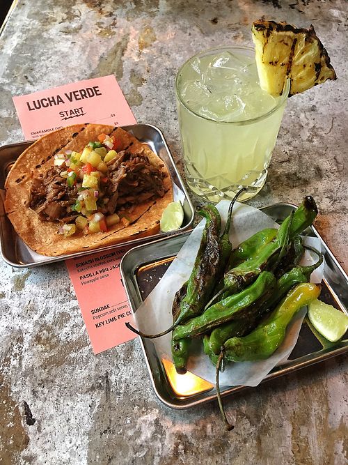 Limo Wreck (mezcal) cocktail, Pasillo BBQ Jackfruit taco, blistered shisho peppers. at Lucha Verde in Vancouver