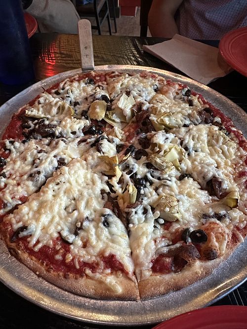 Vegan pizza with artichoke hearts, olives, and onions.   at Extreme Pizza in Arlington