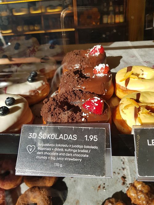 THIS IS THE BEST DOUGHNUT ❤️ dark chocolate with strawberry, those crumbs are amazing! at Holy Donut - Vokiečių in Vilnius