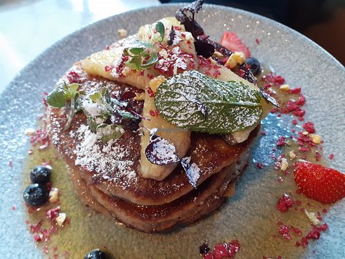Vegan oatmilk pancakes with banana and maple syrup. at Greasy Spoon - Hagagatan in Stockholm