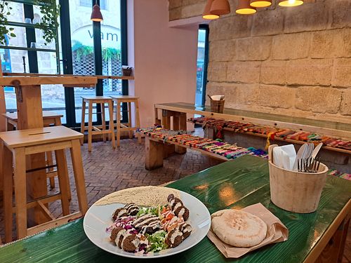 Interior and 'assiette' dish with falafel, hummus, veggies, and pita at Green Lab in Montpellier