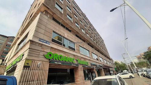 Located on the opposite side of the road behind or to the north of Emart (Chinggis branch) at Organic Market in Ulaanbaatar