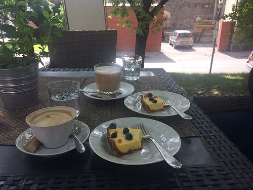 Vegan mango cake with some cappuccino and latte!  at Cafe 7 Bar in Cesis