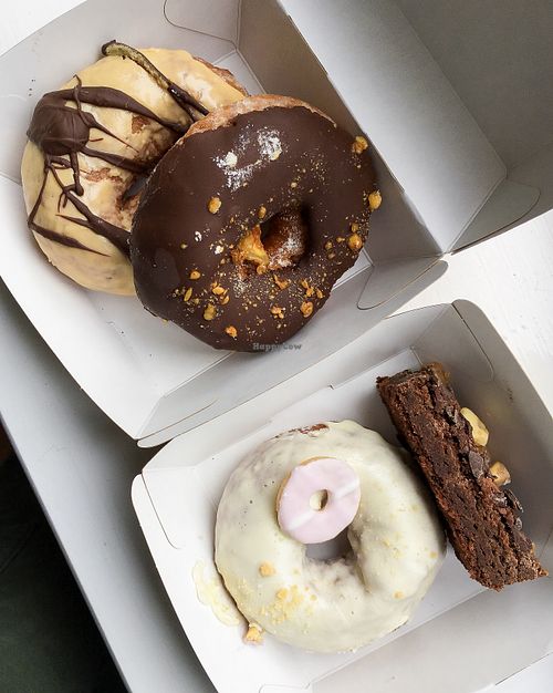 (from top left to bottom right) salted caramel and chocolate doughnut,, chocolate honeycomb doughnut,, vanilla party ring doughnut,, chocolate brownie at In Bloom in Glasgow