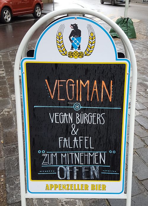 Vegiman sign for vegan burgers and falafel at Vegiman - Feldberg Kiosk in Basel