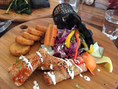 Charcoal bubble waffles with a side of hash browns at Handsome Her in Brunswick